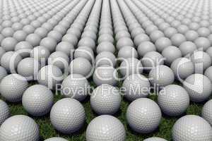 Hundreds of golf balls lined up on a meadow