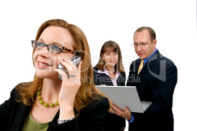 Business Woman on Phone with Coworkers Behind