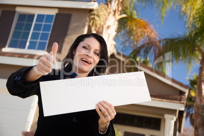 Attractive Hispanic Woman Holding Blank Sign in Front of House