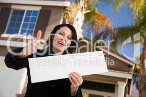 Attractive Hispanic Woman Holding Blank Sign in Front of House