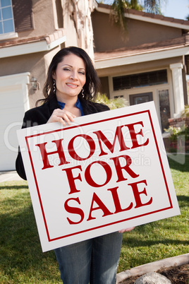 Woman Holding Home For Sale Real Estate Sign In Front of House