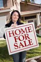 Woman Holding Home For Sale Real Estate Sign In Front of House