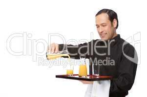 Waiter pouring juice