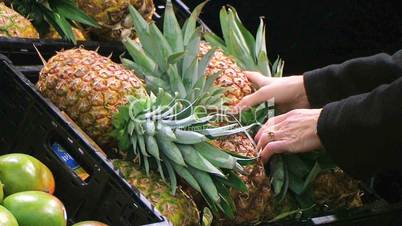 Woman Selects Pineapple