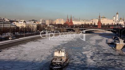 Moscow Kremlin and winter river with traffic at winter sunset