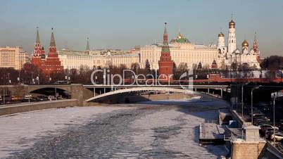 Moscow Kremlin and winter river with traffic at winter sunset