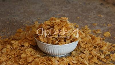 Cereal flakes overflowing bowl reverse