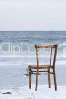 Chair washed ashore and facing the ocean