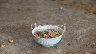 Cereal colored loops pour into bowl