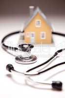 Stethoscope and Model House on Gradated Background