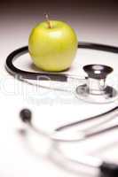 Stethoscope and Green Apple on Gradated Background