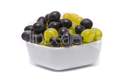 Green and blue grapes on a studio white background