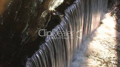 HD Little waterfalls sparkling in sunlight, closeup