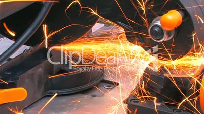 HD Closeup of a metal cutting saw slicing through a steel