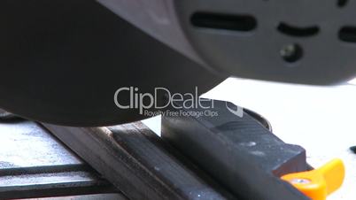 HD Closeup of a metal cutting saw slicing through a steel section