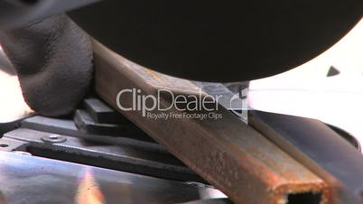 HD Circular saw blade teeth coming through metall, closeup