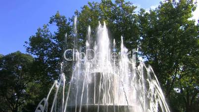 HD Fountain in park, blue sky and trees background