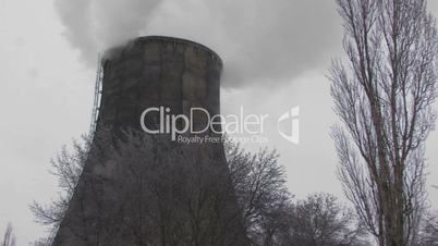 HD Coal burning power station with trees on foreground