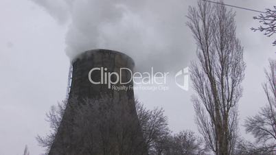 HD Coal burning power station with trees on foreground