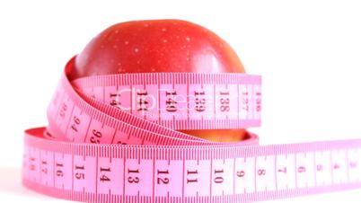 Red apple with tape measure rotates , loopable