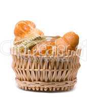 Fresh baked rolls in a basket on white