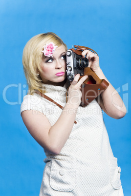 Blond girl with retro camera look aside