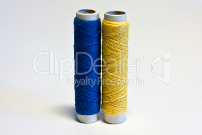 blue and yellow spools of thread