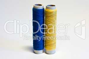 blue and yellow spools of thread