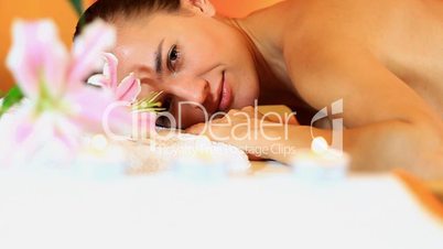Topless woman in spa looks at camera