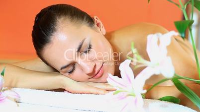 Topless woman in spa looks at camera and smiles