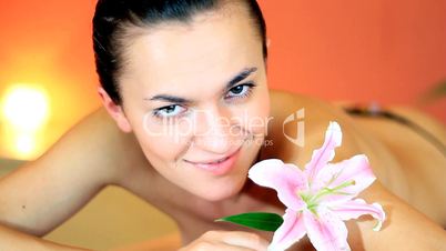 Young beautiful smiling woman with flower