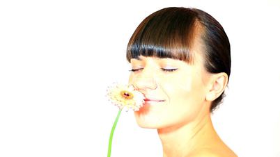 Young sexy woman smelling flower