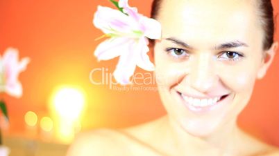 Portrait of young beautiful smiling woman with flower