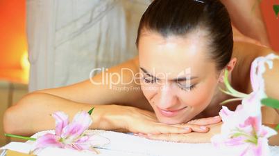 Young woman receiving massage at spa resort