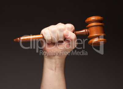 Male Fist Holding Wooden Gavel