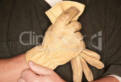 Man Putting on Leather Construction Gloves