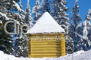 Log cabin in snowy forest