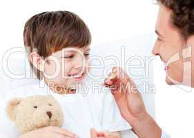 Enthusiastic doctor taking little boy's temperature