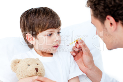 Caucasian doctor taking little boy's temperature