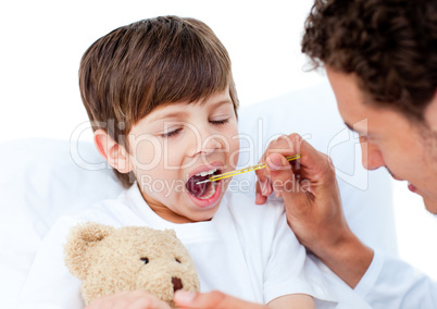 Doctor taking little boy's temperature