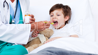 Little boy taking cough medicine