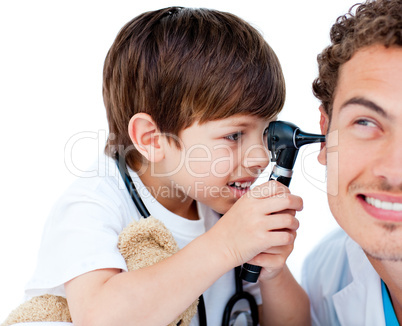 Cute child checking doctor's ears