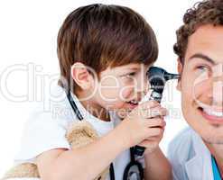 Cute child checking doctor's ears