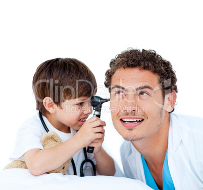 Smiling little boy playing with the doctor