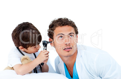 Cute little boy checking doctor's ears