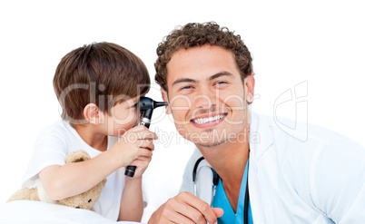 Little boy checking doctor's ears