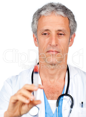 Serious doctor presenting a syringe
