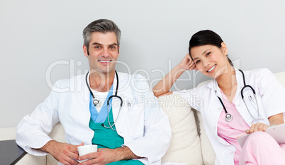 Two doctors relaxing and drinking coffee