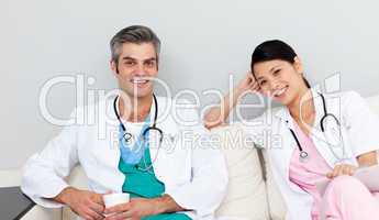 Two doctors relaxing and drinking coffee