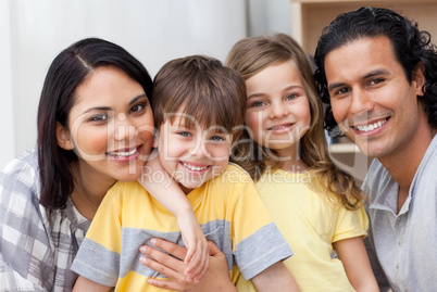 family hugging in the kitchen